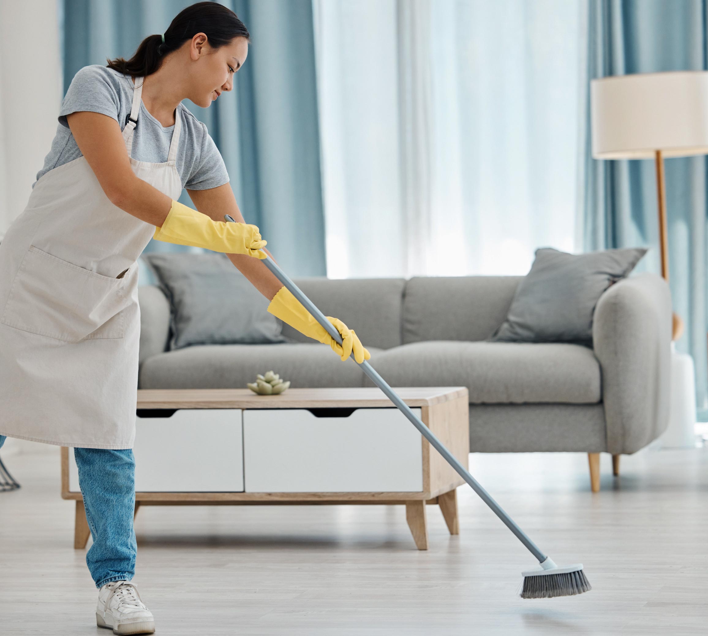 Housekeeper performing cleaning services for Singapore households