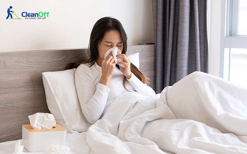 Woman sneezing due to a lack of dust mite prevention