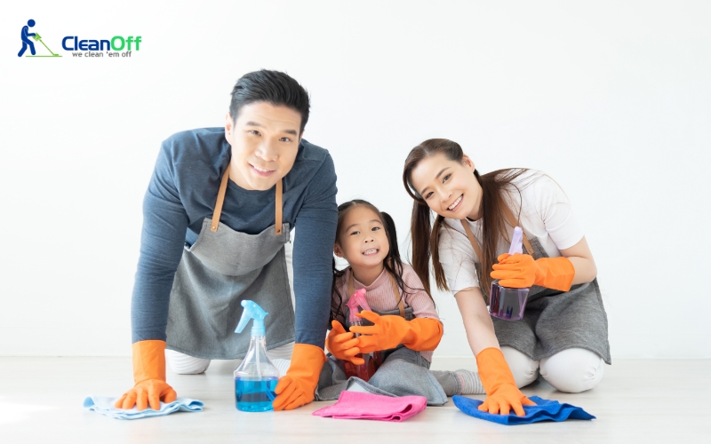 Happy family cleaning the house together