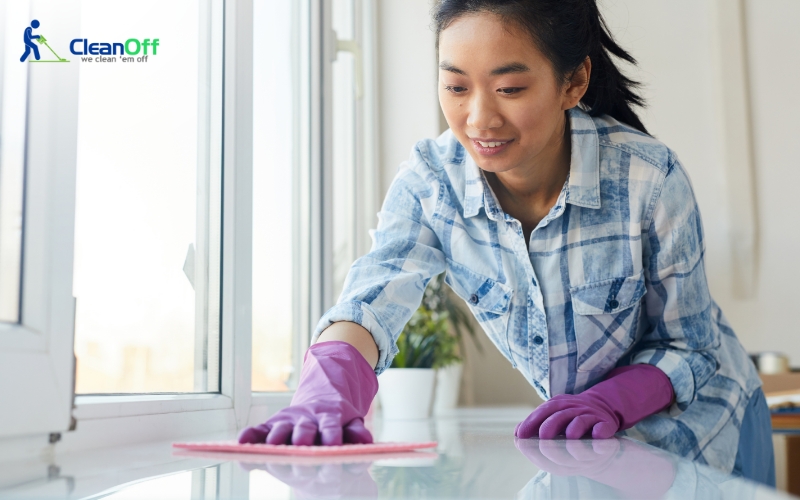 Woman in gloves cleaning the countertop