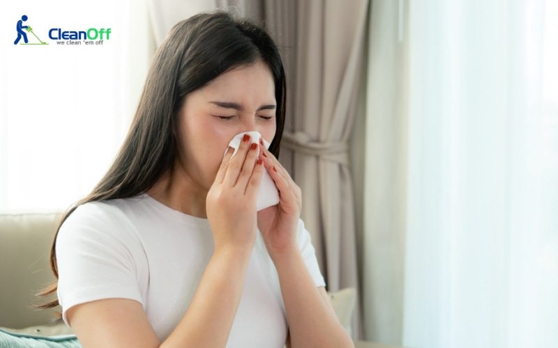 Woman sneezing due to indoor mould exposure
