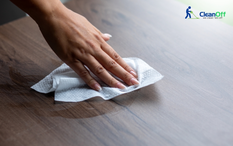 Woman wiping the floor with a wet tissue