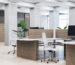 Spacious modern office with clean desks and white chairs.